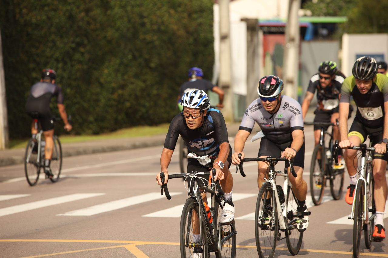 Competitive cyclists racing on a sunny day, showcasing determination and endurance.