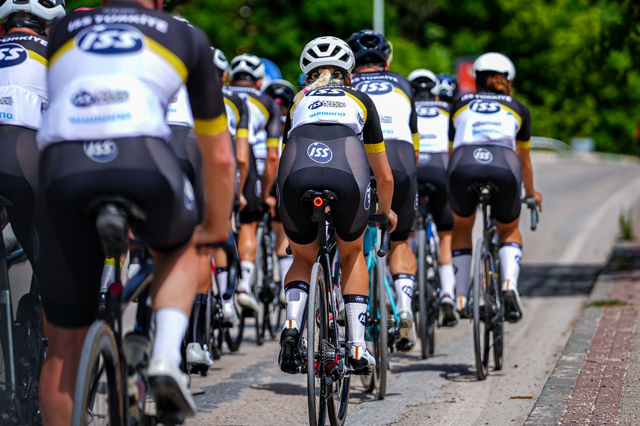 Group of professional cyclists competing in a street race in Bursa, Türkiye.
